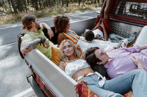Group of People Lying on White Wooden Bench
